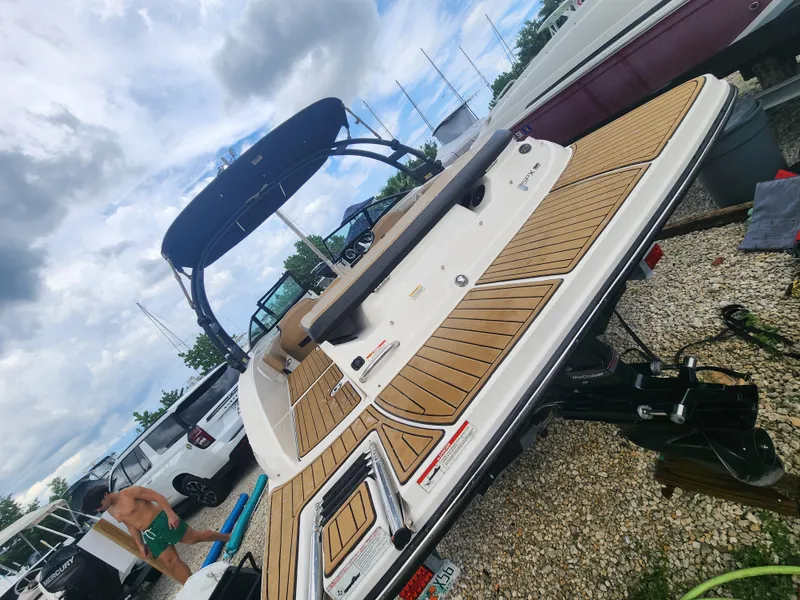 Slide: The Image of 2020 Sea Ray SPX 190 boat on trailer, under cloudy sky. - 4