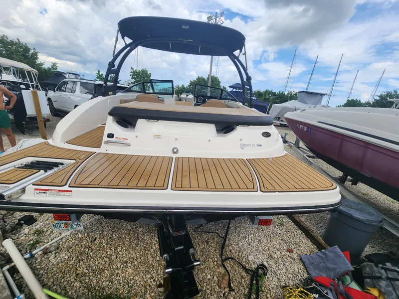 Slide: The Image of 2020 Sea Ray SPX 190 boat with teak deck, parked on gravel lot. - 8