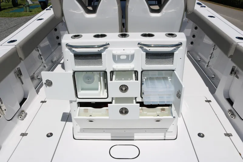 Slide: The Image of 2025 Sportsman Open 262 Center Console boat interior with storage compartments and seating. - 10