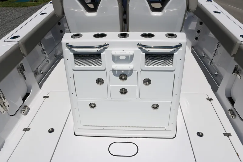 Slide: The Image of 2025 Sportsman Open 262 Center Console boat interior with storage compartments and cup holders. - 11