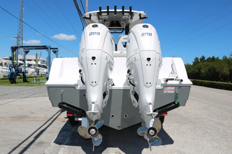 Slide: The Image of 2025 Sportsman Open 262 Center Console with dual outboard engines, rear view. - 5