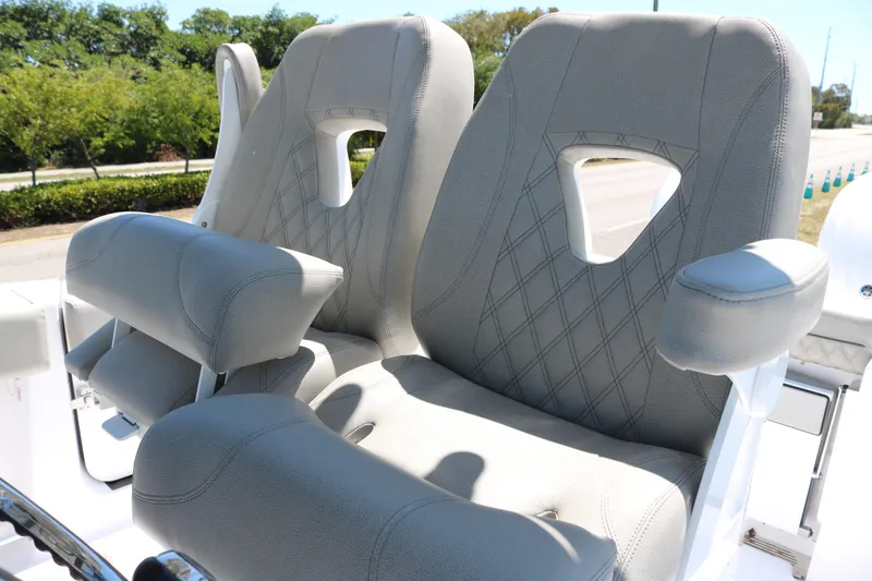 Slide: The Image of 2025 Sportsman Open 262 Center Console boat seats with diamond stitching and armrests. - 7