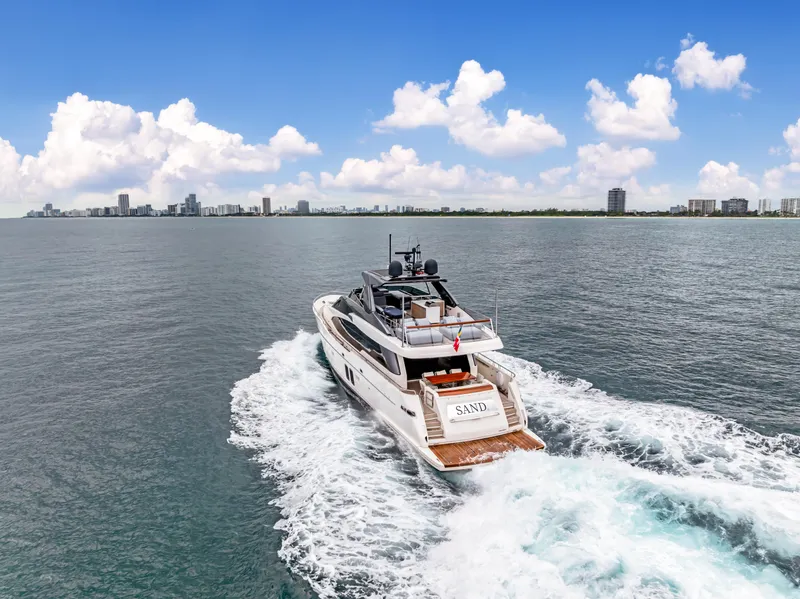 Slide: The Image of Sanlorenzo SL78 yacht cruising on open water, 2018 model, city skyline in background. - 15