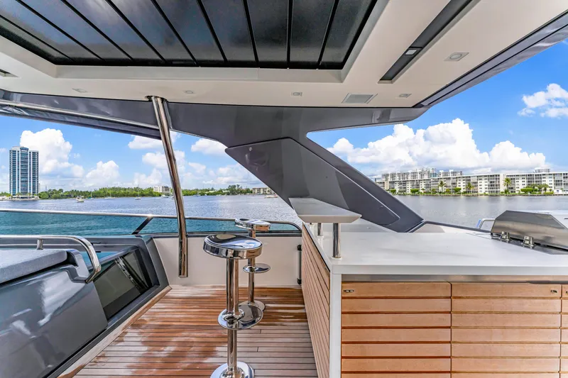 Slide: The Image of Luxurious 2018 Sanlorenzo SL78 yacht deck with modern bar and scenic waterfront view. - 23