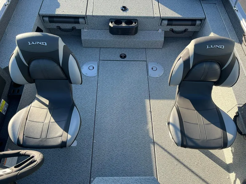 Slide: The Image of 2025 Lund 1775 Impact XS Sport boat interior with two seats and storage compartments. - 11