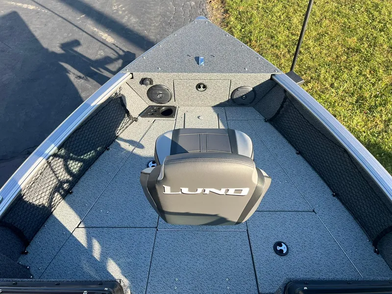 Slide: The Image of 2025 Lund 1775 Impact XS Sport boat interior with seating and storage. - 12