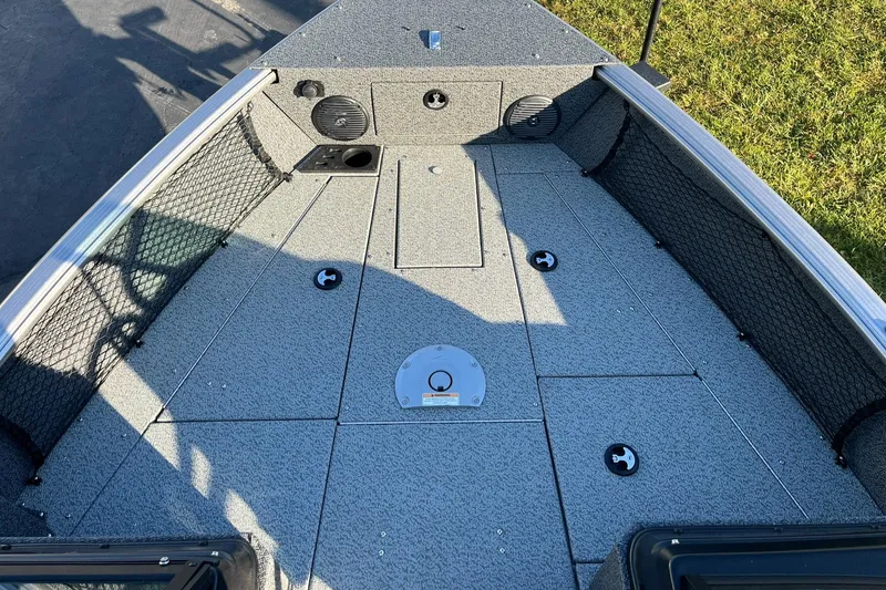 Slide: The Image of 2025 Lund 1775 Impact XS Sport boat deck with storage compartments and speakers. - 13