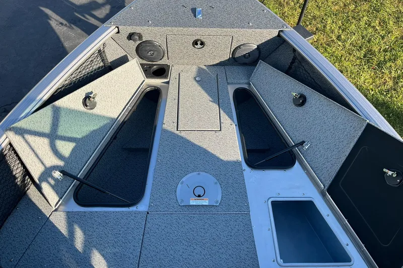 Slide: The Image of 2025 Lund 1775 Impact XS Sport boat interior with storage compartments and speakers. - 14