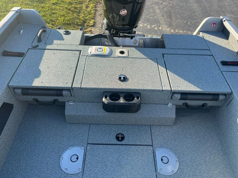 Slide: The Image of 2025 Lund 1775 Impact XS Sport boat deck with storage compartments and motor. - 15