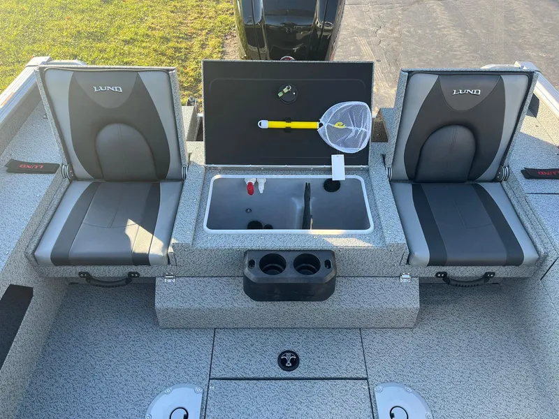 Slide: The Image of 2025 Lund 1775 Impact XS Sport boat interior with seating and storage compartments. - 16