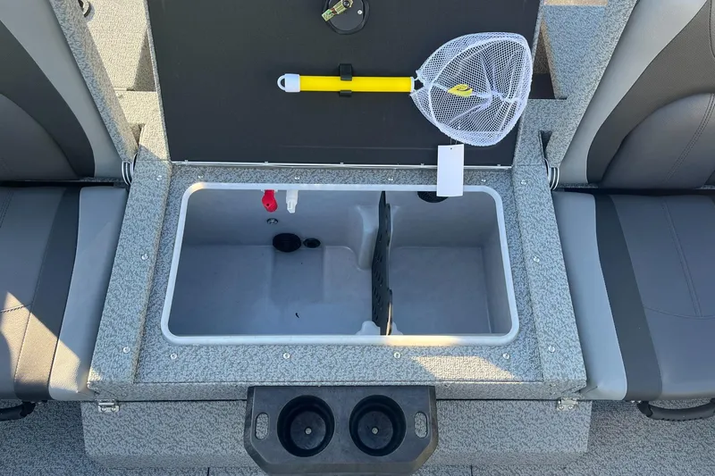 Slide: The Image of 2025 Lund 1775 Impact XS Sport boat interior with storage compartment and fishing net. - 17