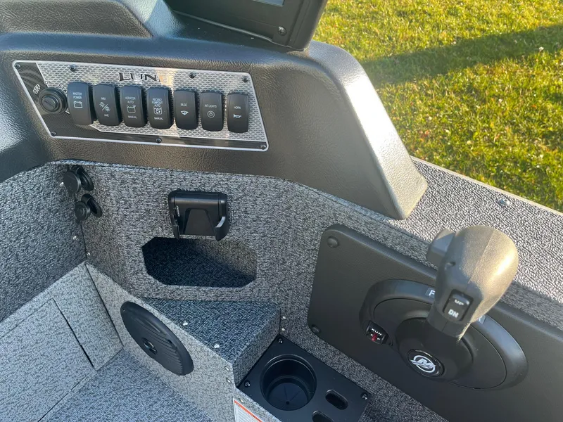 Slide: The Image of 2025 Lund 1775 Impact XS Sport boat dashboard with control panel and speaker. - 18