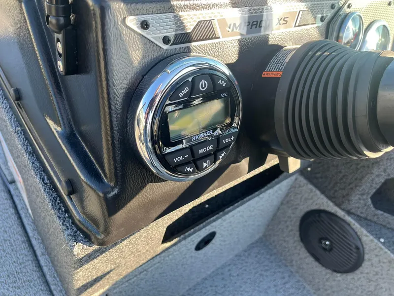 Slide: The Image of 2025 Lund 1775 Impact XS Sport boat dashboard with audio controls. - 21