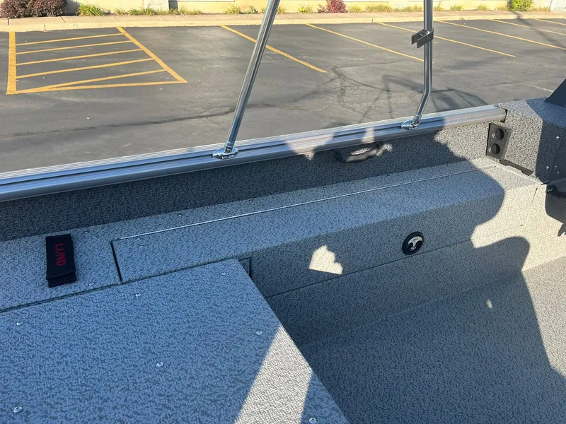 Slide: The Image of 2025 Lund 1775 Impact XS Sport boat interior with gray textured flooring. - 22