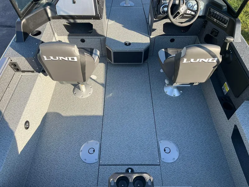 Slide: The Image of 2025 Lund 1775 Impact XS Sport boat interior with two seats and steering console. - 7