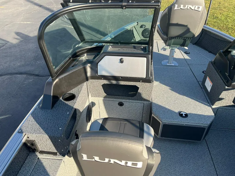 Slide: The Image of 2025 Lund 1775 Impact XS Sport boat interior with seating and console. - 8