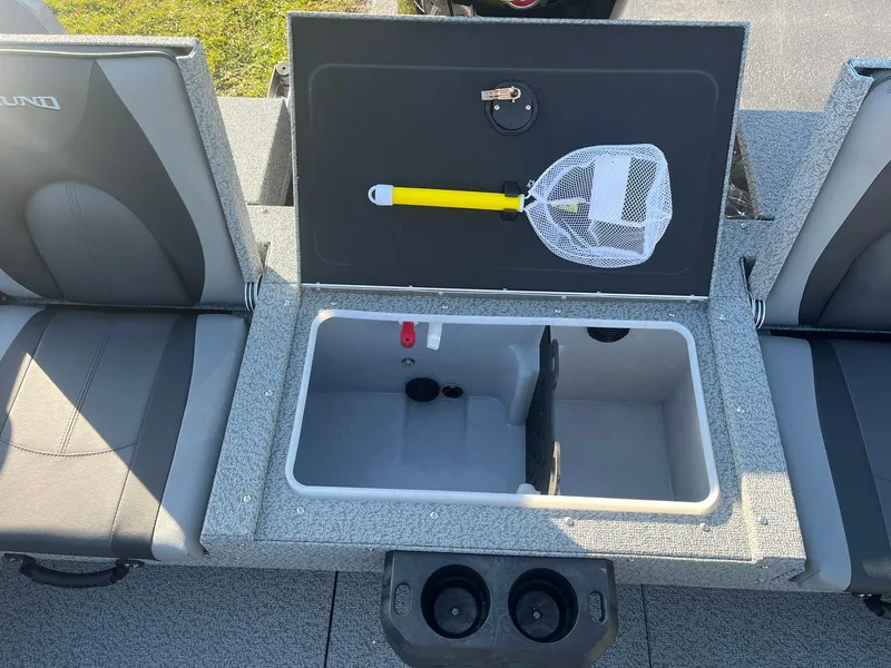 Slide: The Image of 2025 Lund 1775 Impact XS SS boat interior with open storage compartment and fishing net. - 10