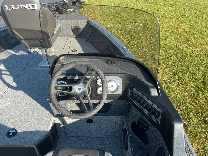 Slide: The Image of 2025 Lund 1775 Impact XS SS boat interior with steering wheel and dashboard. - 12