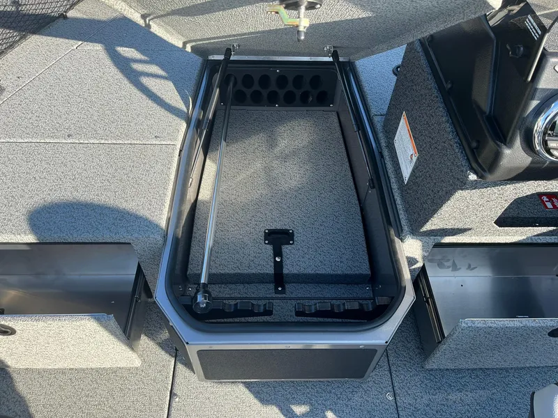 Slide: The Image of 2025 Lund 1775 Impact XS SS boat interior storage compartment with open lid. - 14