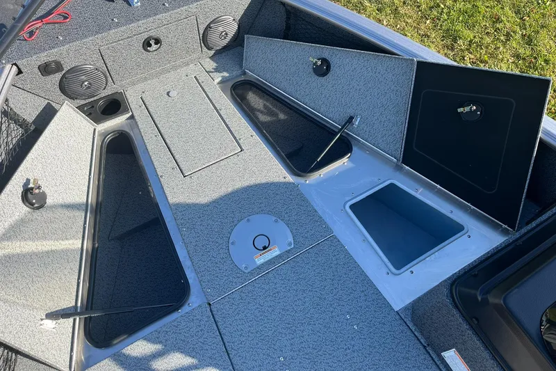 Slide: The Image of 2025 Lund 1775 Impact XS SS boat interior with open storage compartments. - 16