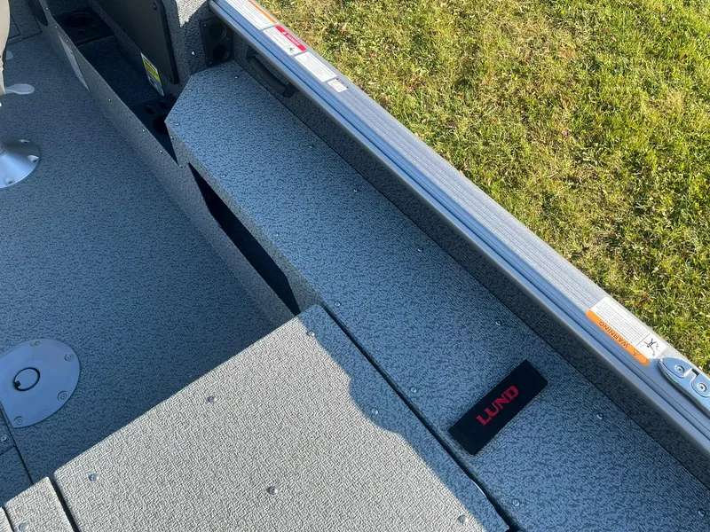 Slide: The Image of 2025 Lund 1775 Impact XS SS boat interior with textured flooring and seating. - 17