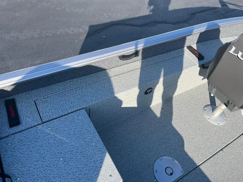 Slide: The Image of 2025 Lund 1775 Impact XS SS boat interior with shadow and seating detail. - 18