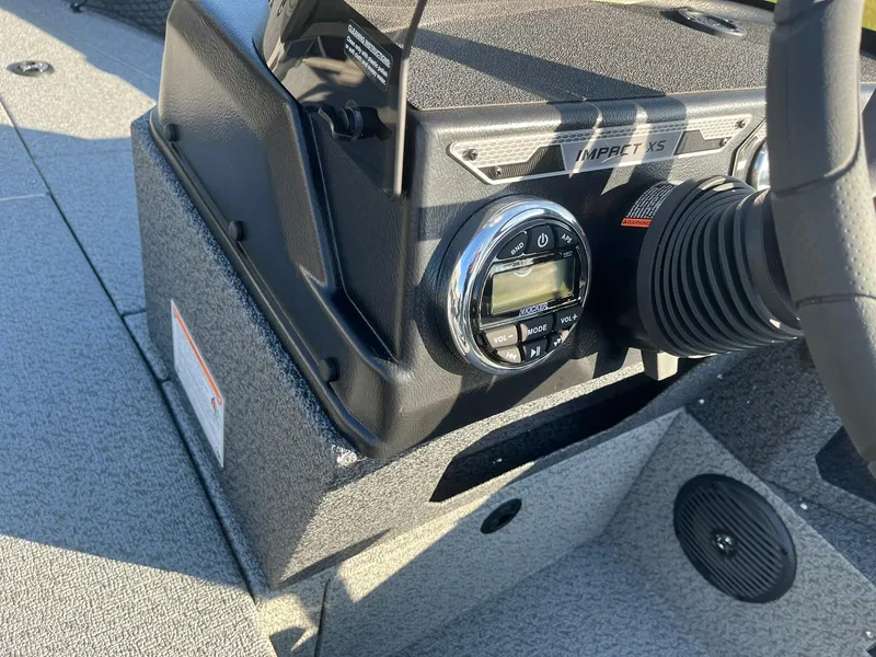 Slide: The Image of 2025 Lund 1775 Impact XS SS boat dashboard with control panel and steering wheel. - 21