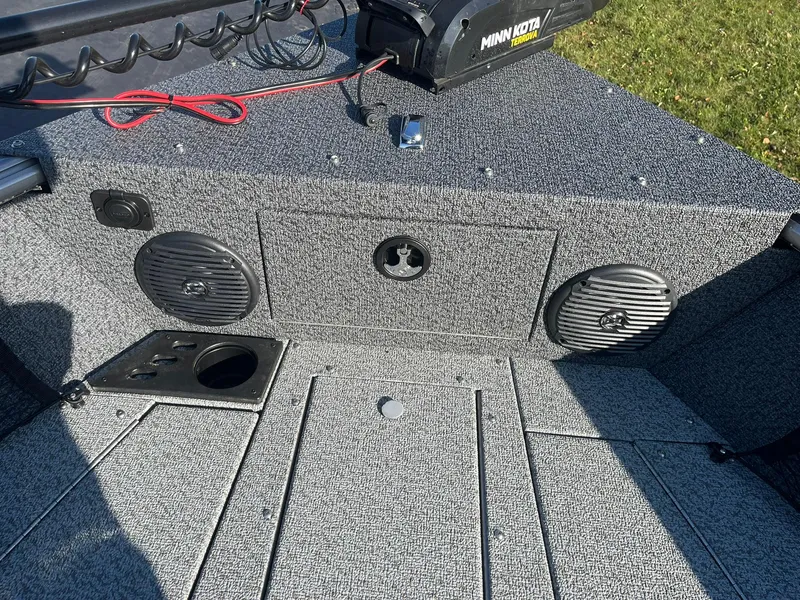 Slide: The Image of 2025 Lund 1775 Impact XS SS boat interior with speakers and Minn Kota motor. - 23