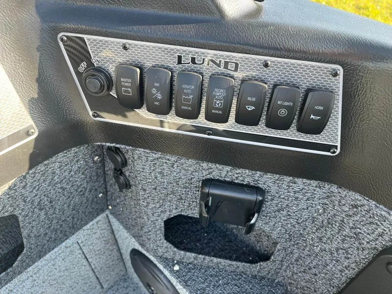 Slide: The Image of Control panel of 2025 Lund 1775 Impact XS SS boat with various switches. - 25