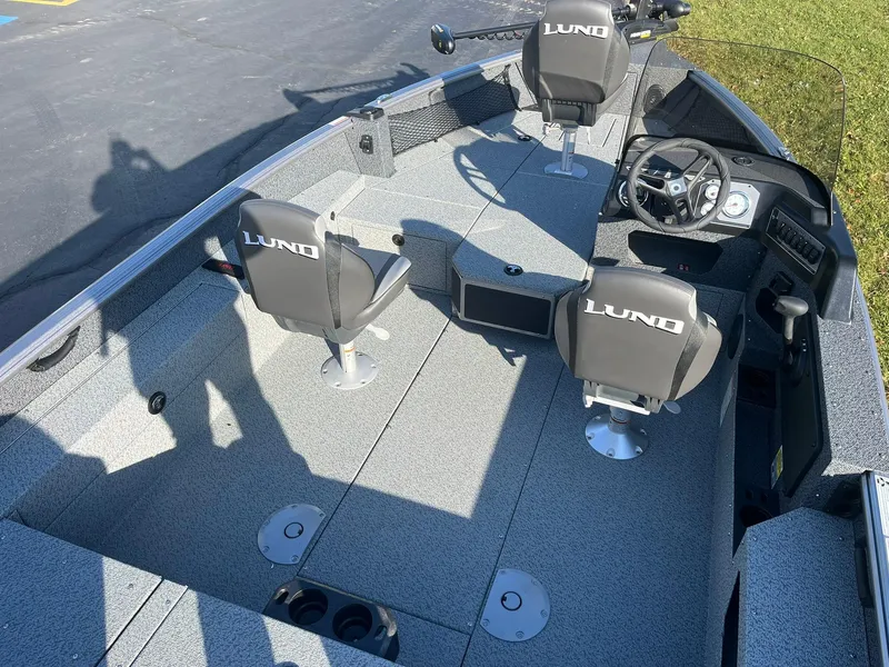 Slide: The Image of 2025 Lund 1775 Impact XS SS boat interior with seating and steering console. - 5