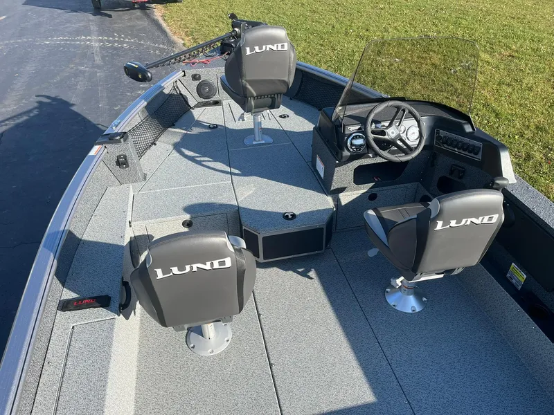 Slide: The Image of 2025 Lund 1775 Impact XS SS boat interior with seating and steering console. - 6