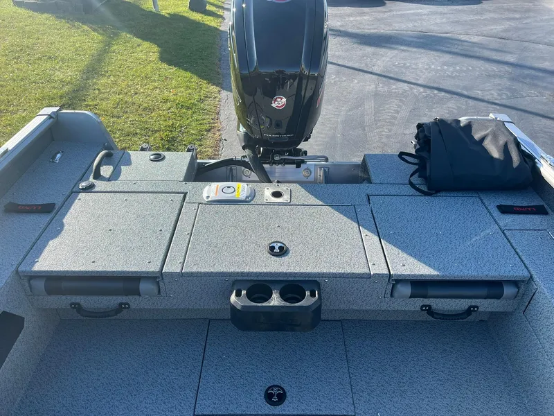 Slide: The Image of 2025 Lund 1775 Impact XS SS boat interior with motor and storage compartments. - 9