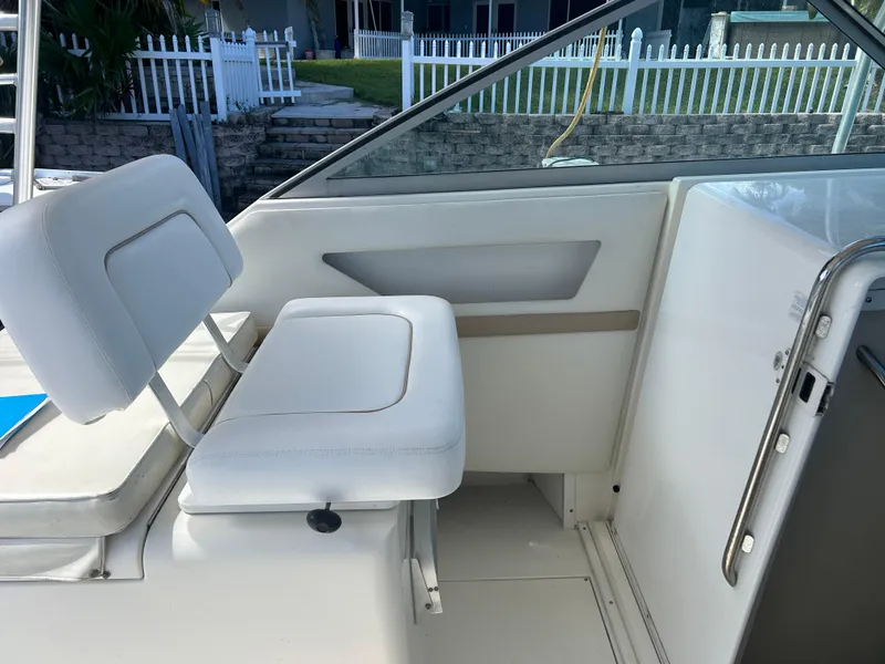 Slide: The Image of 1999 Wellcraft 330 Coastal boat interior with white seating and sleek design. - 24