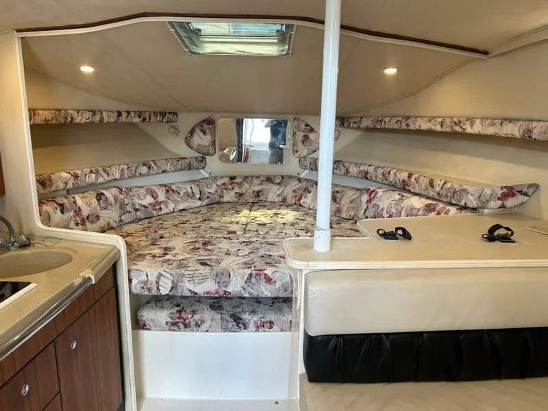 Slide: The Image of 1999 Wellcraft 330 Coastal cabin interior with floral upholstery and kitchenette. - 26