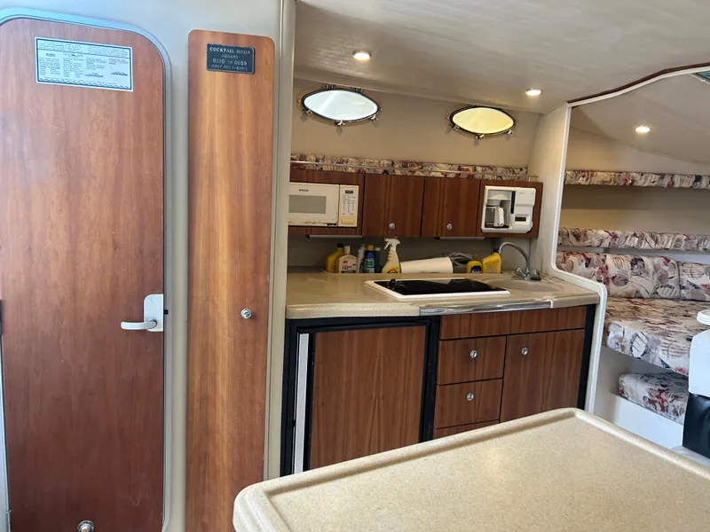 Slide: The Image of Interior of 1999 Wellcraft 330 Coastal boat with kitchenette and seating area. - 28