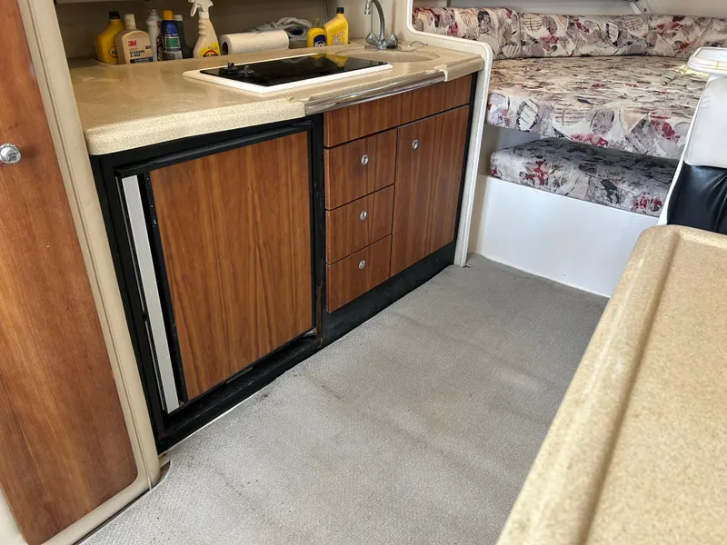 Slide: The Image of 1999 Wellcraft 330 Coastal interior with kitchenette and seating area. - 37