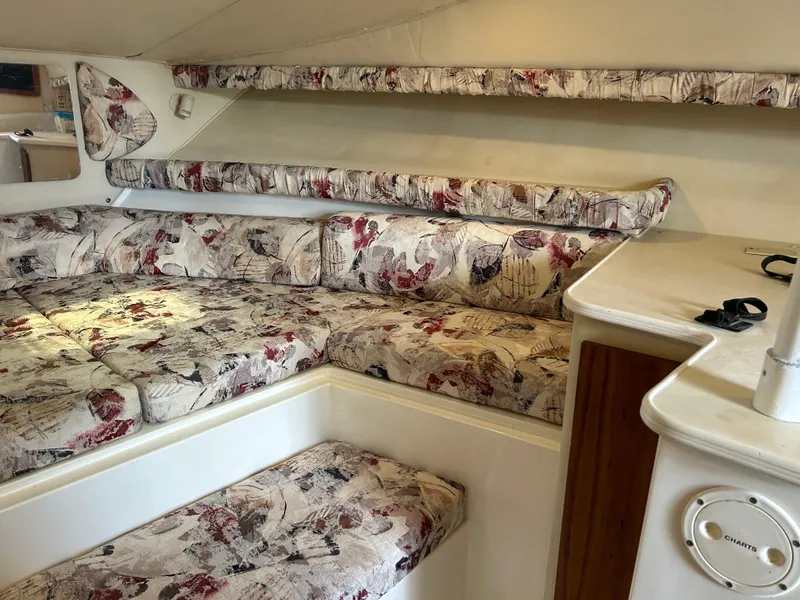 Slide: The Image of 1999 Wellcraft 330 Coastal interior with floral-patterned seating and white cabinetry. - 39