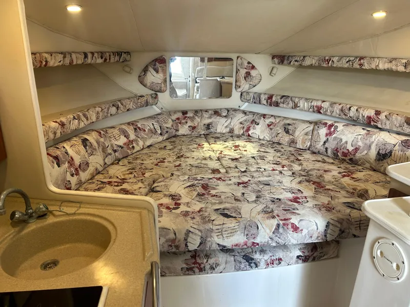 Slide: The Image of Interior of 1999 Wellcraft 330 Coastal boat with floral-patterned seating and compact sink. - 45
