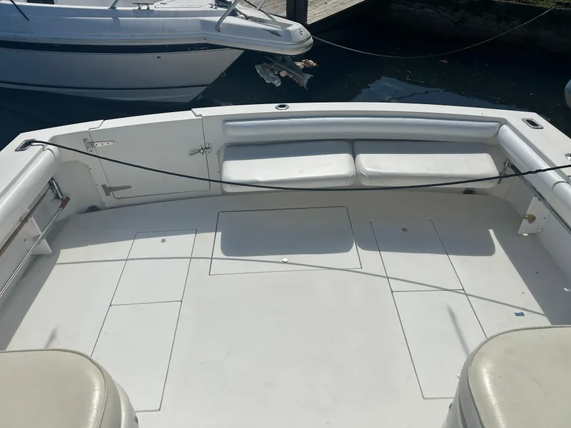 Slide: The Image of 1999 Wellcraft 330 Coastal boat deck with seating and storage compartments. - 6