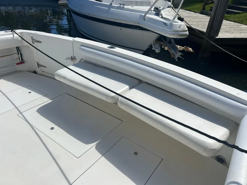 Slide: The Image of 1999 Wellcraft 330 Coastal boat interior with white seating and storage compartments. - 7