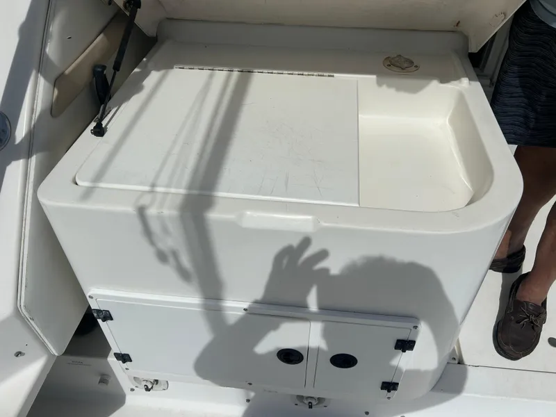 Slide: The Image of 1999 Wellcraft 330 Coastal boat interior with storage compartment and shadow. - 9