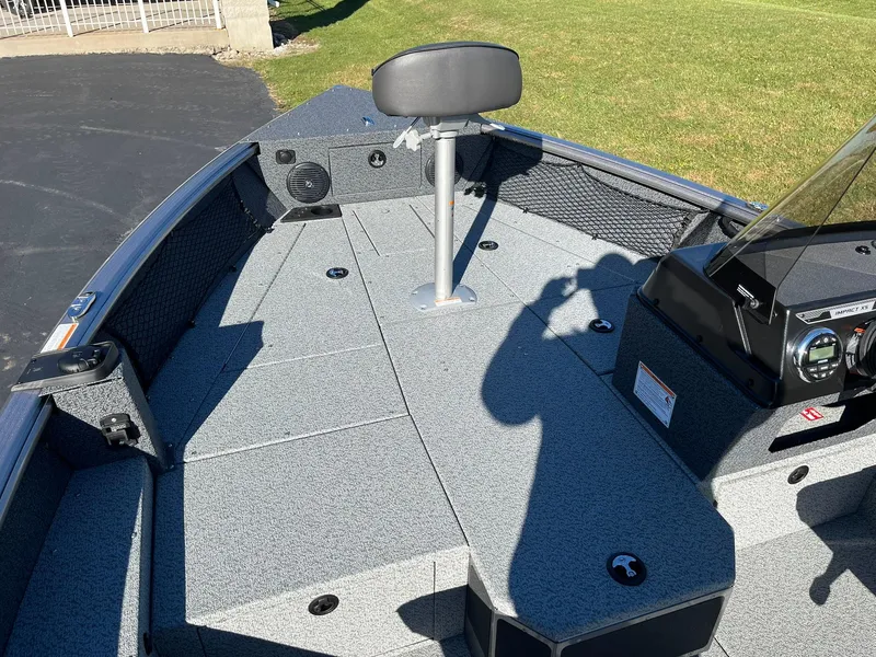 Slide: The Image of 2025 Lund 1875 Impact XS SS boat interior with seating and storage compartments. - 10