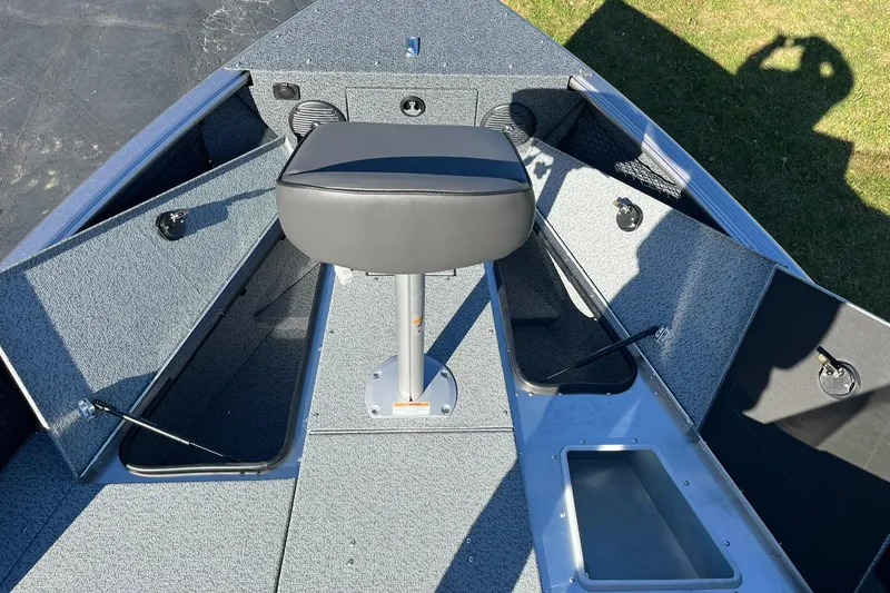 Slide: The Image of 2025 Lund 1875 Impact XS SS boat interior with seating and storage compartments. - 11