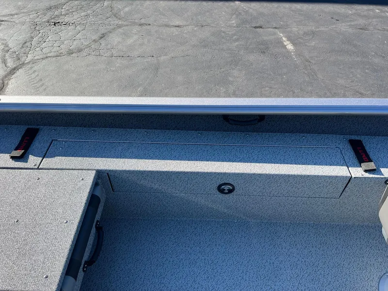 Slide: The Image of 2025 Lund 1875 Impact XS SS boat interior with storage compartments. - 18