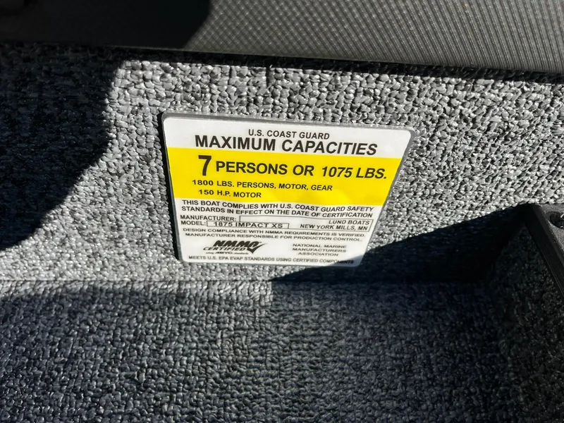 Slide: The Image of Capacity label on 2025 Lund 1875 Impact XS SS boat, 7 persons or 1075 lbs. - 24