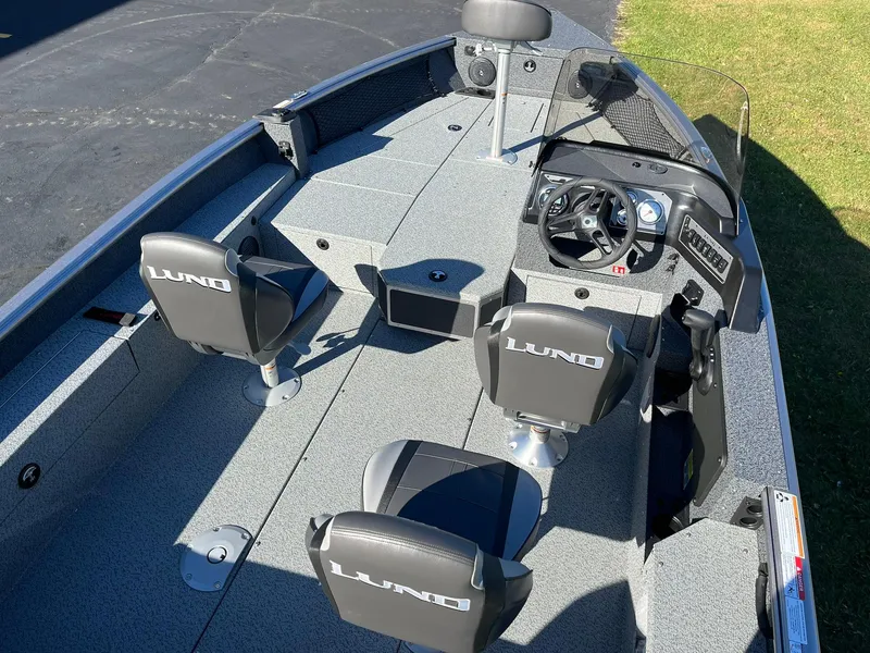 Slide: The Image of 2025 Lund 1875 Impact XS SS boat interior with seating and steering console. - 5