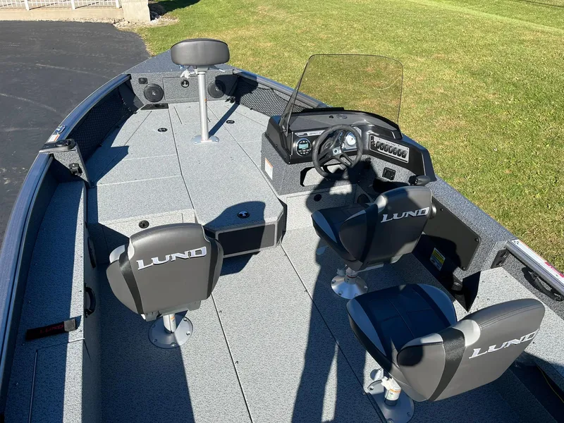 Slide: The Image of 2025 Lund 1875 Impact XS SS fishing boat interior with seating and steering console. - 6