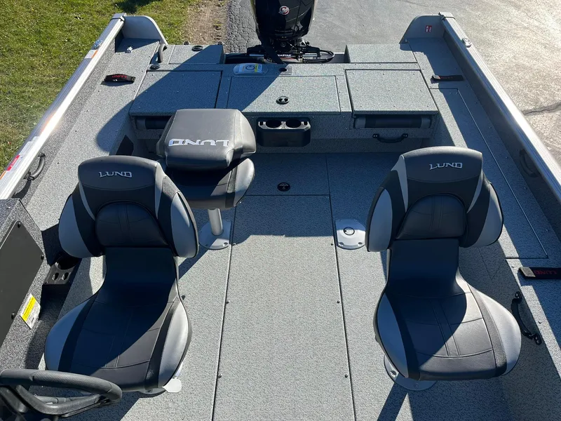 Slide: The Image of 2025 Lund 1875 Impact XS SS boat interior with two seats and storage compartments. - 7