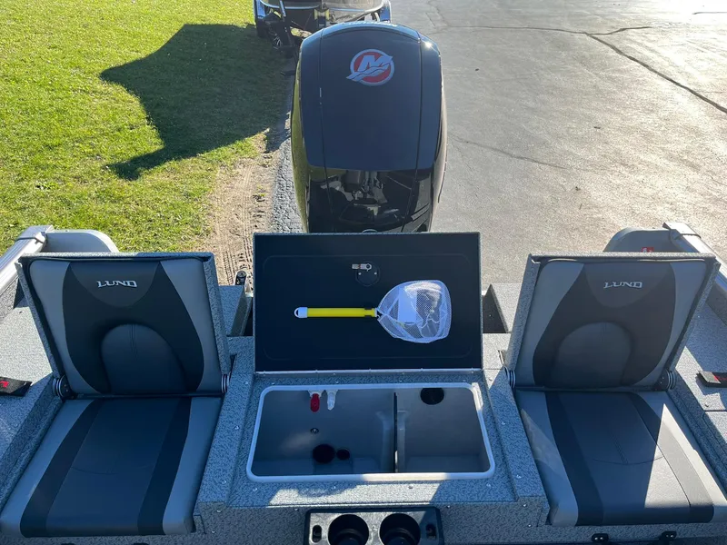 Slide: The Image of 2025 Lund 1875 Impact XS SS boat interior with seating and storage compartments. - 8