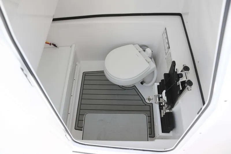 Slide: The Image of 2025 Sportsman Open 282 boat interior with compact marine toilet. - 12